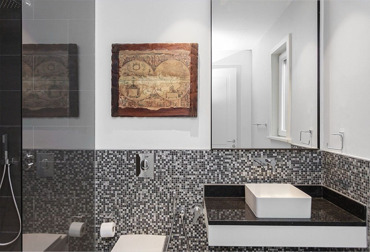 Modern bathroom with mosaic tiles in Luštica Bay villa, Radovići, Montenegro: shower and stylish sink.