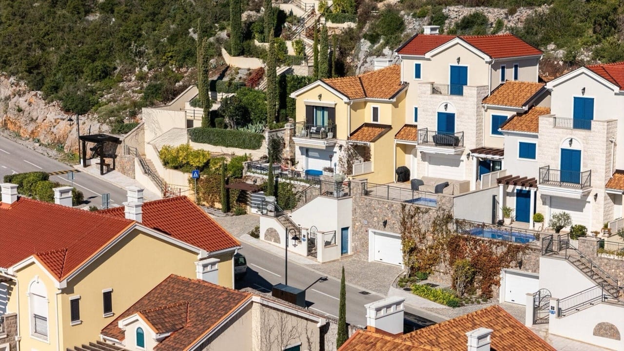 View of modern villas with tiled roofs in the upscale Luštica Bay complex, Radovići, Montenegro.