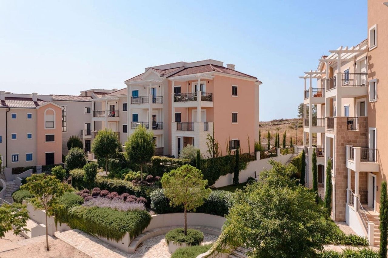 Modern residential complex in Luštica Bay, Radovići, Montenegro: low-rise buildings with terraces and a well-kept garden.