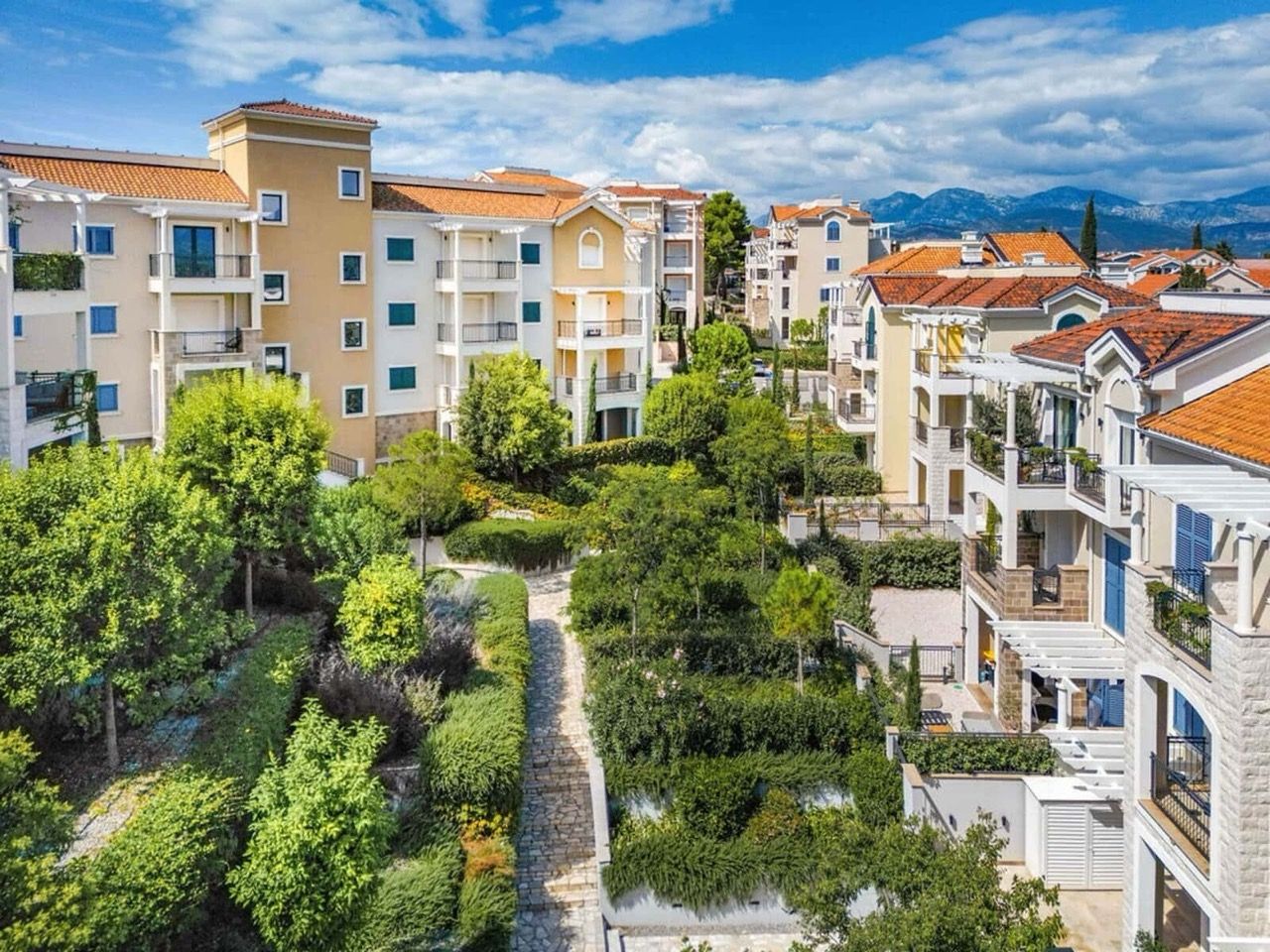 Lustica Bay residential complex in Radovici, Montenegro: modern houses with terraces and a well-kept green garden.
