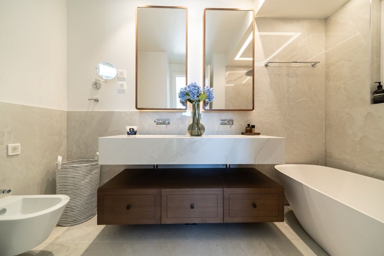 Modern bathroom in an apartment in Luštica Bay, Radovići, Montenegro: marble countertop and freestanding bathtub.