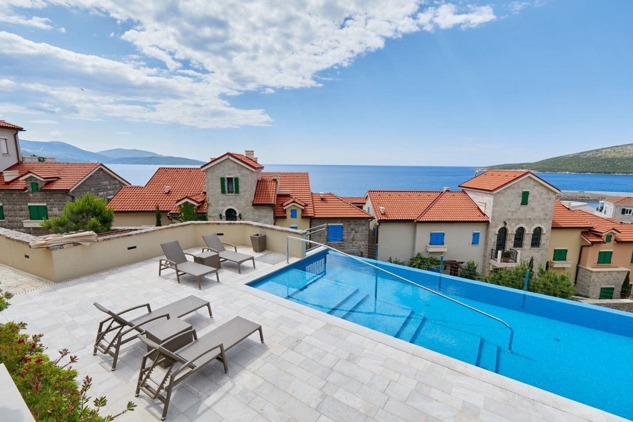 Infinity pool with sun loungers and panoramic sea views in Luštica Bay, Radovići, Montenegro.