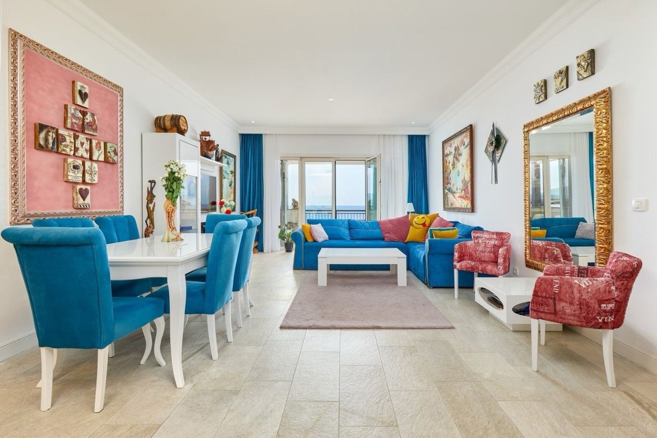 Living room with blue furniture and sea view in an apartment, Luštica Bay, Radovići, Montenegro: stylish interior with decor.