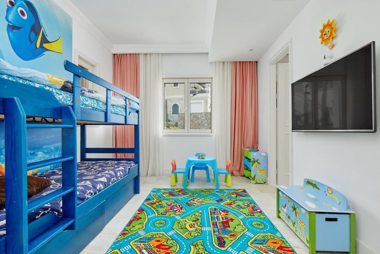 Children's bedroom with a bunk bed in an apartment in Luštica Bay, Radovići, Montenegro: bright furniture and decor.