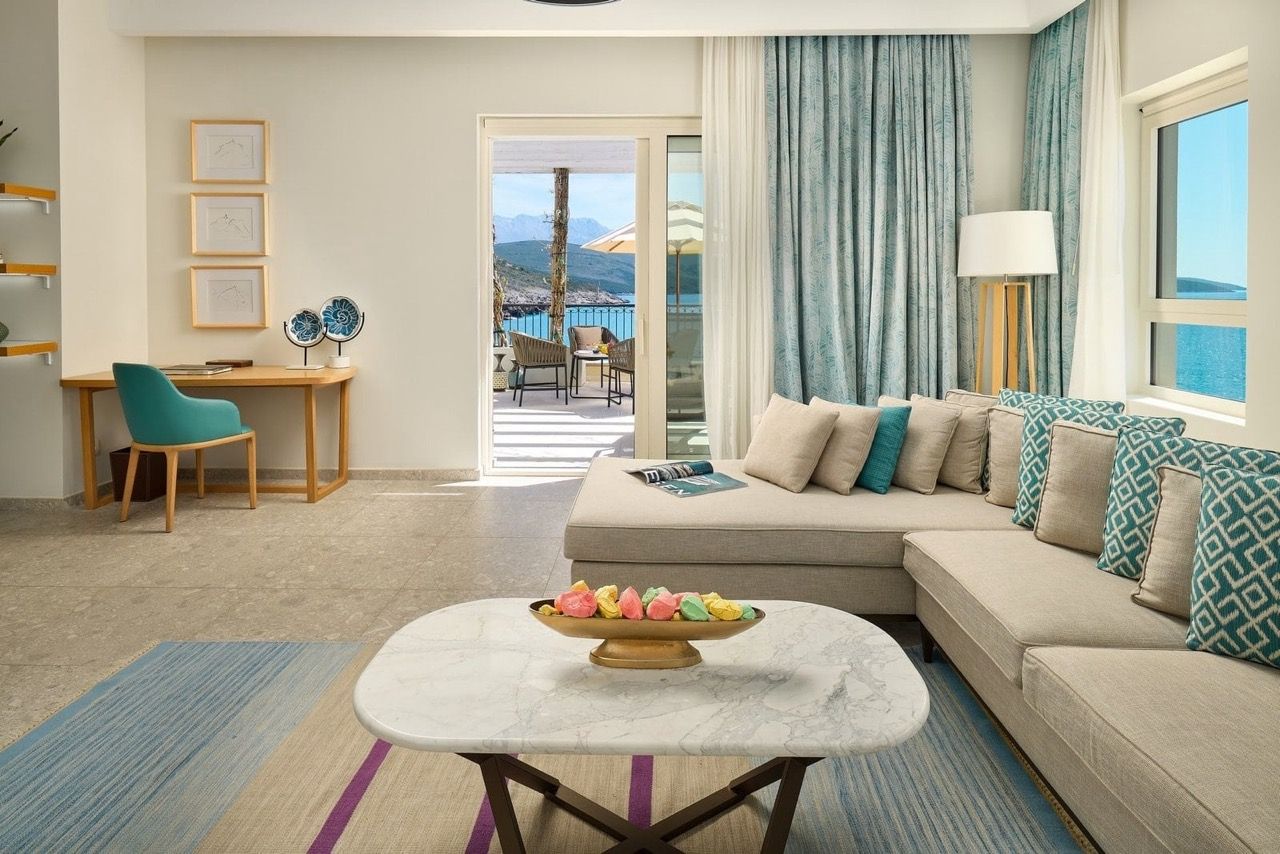 Bright living room in an apartment in Luštica Bay, Radovići, Montenegro: sea view, terrace, modern furniture and decor.