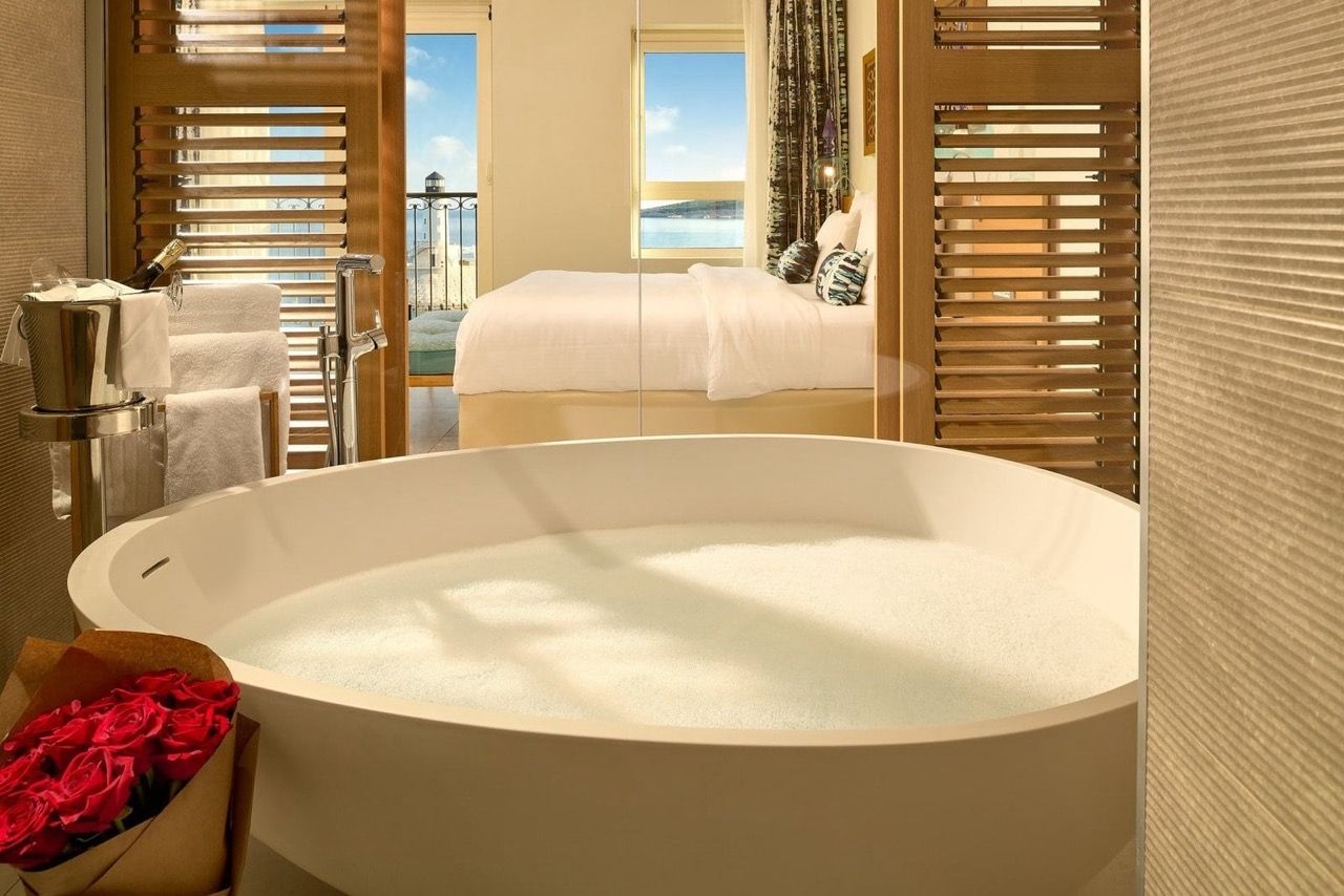 Bathroom with a round bathtub and sea view in Luštica Bay apartments, Radovići, Montenegro.