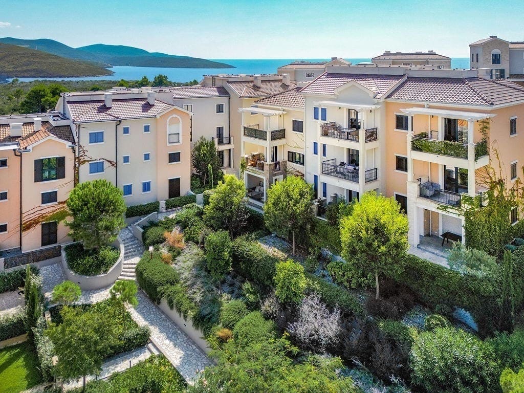 Lustica Bay residential complex in Radovici, Montenegro: view of modern houses with terraces and a green landscaped park.