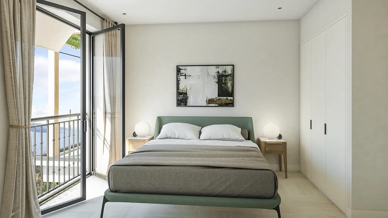 Modern bedroom featuring a green bed frame, white wardrobe, and open glass doors leading to a balcony.