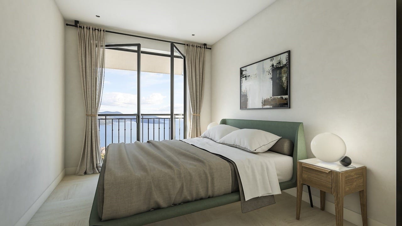 Modern bedroom in an apartment in Luštica Bay, Radovići, Montenegro, with sea view and a panoramic balcony.