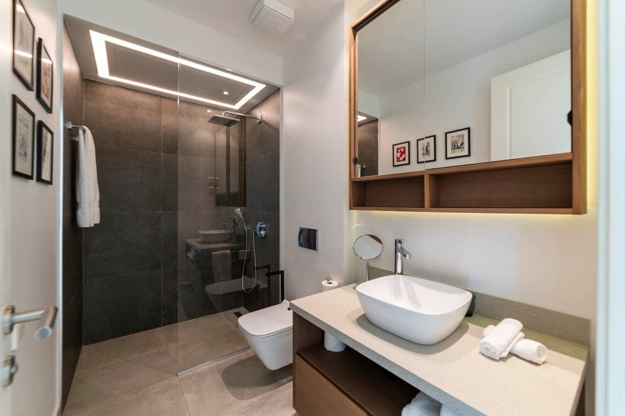 Modern bathroom in an apartment in Luštica Bay, Radovići, Montenegro: shower cabin, stylish fixtures, and decor.