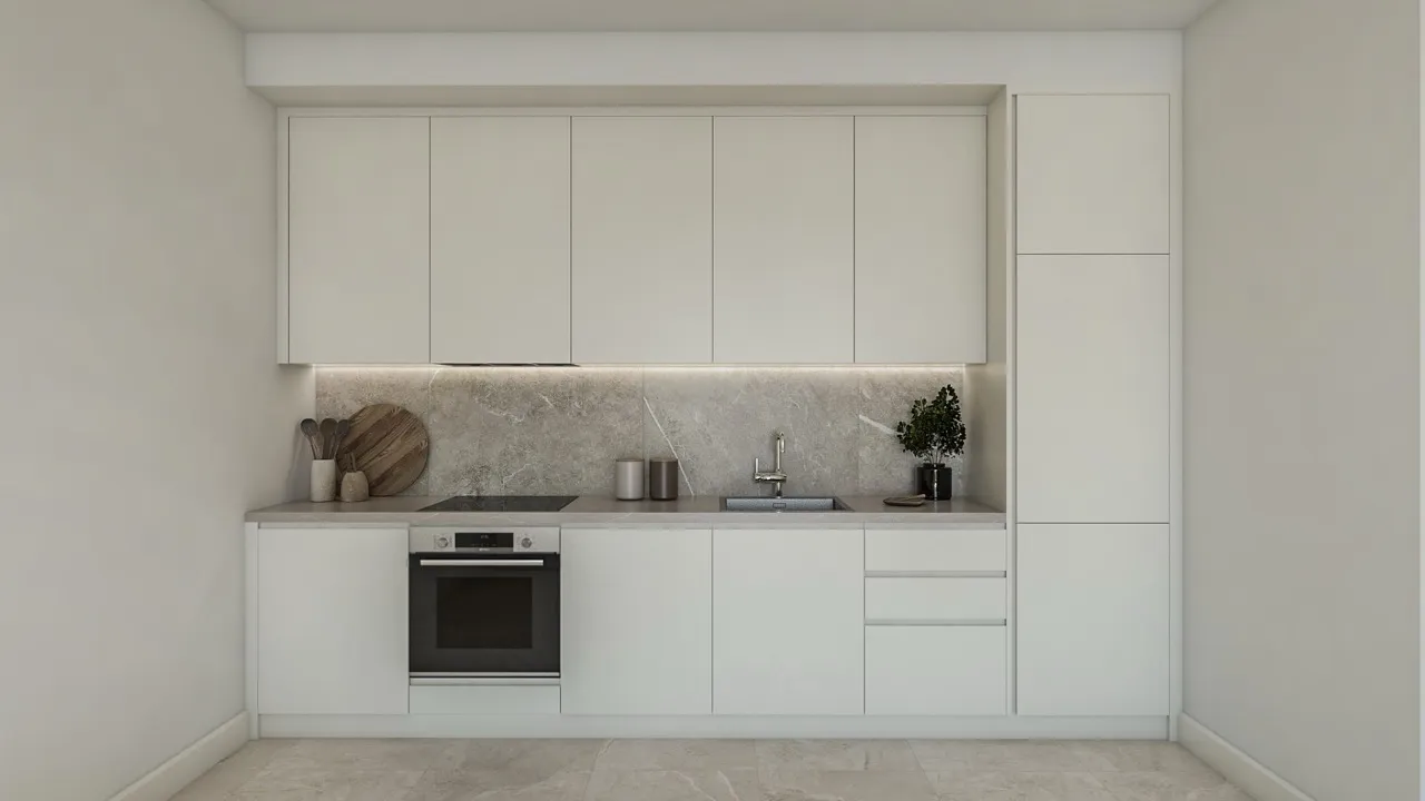 Modern kitchen with white cabinets, built-in oven, sink, and stone countertop.
