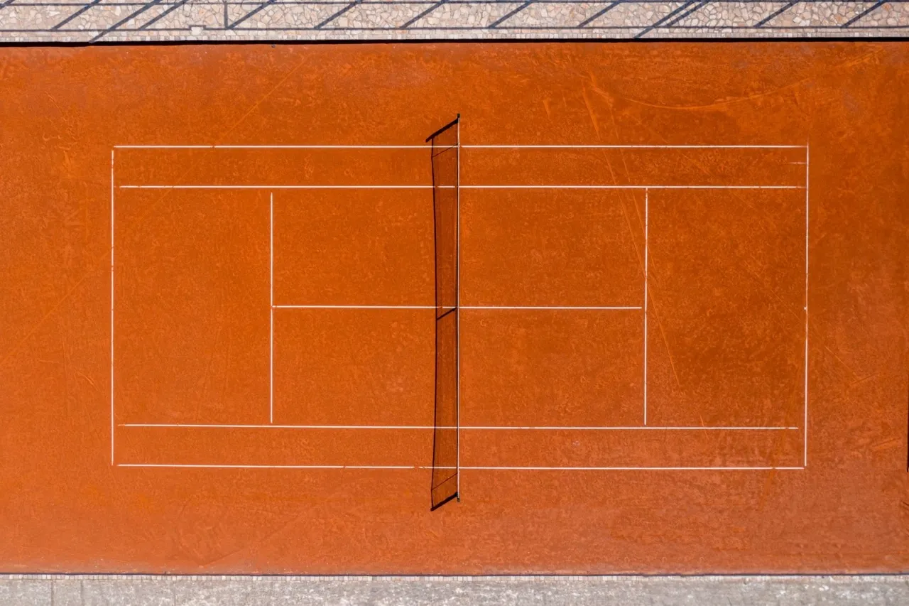 Top-down view of an orange tennis court with white lines and a center net.