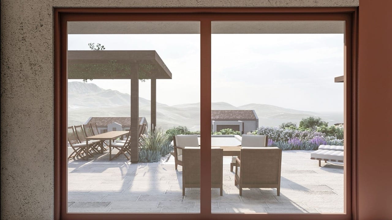 View from the terrace of a villa in Luštica Bay, Montenegro: dining area, sun loungers, and panoramic views of the mountains and sea.