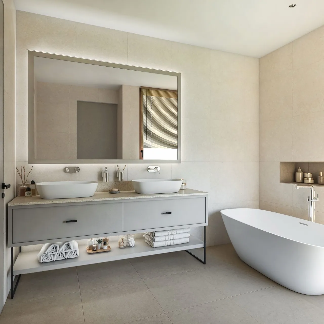 Modern bathroom with double vessel sinks, freestanding tub, and large backlit mirror.