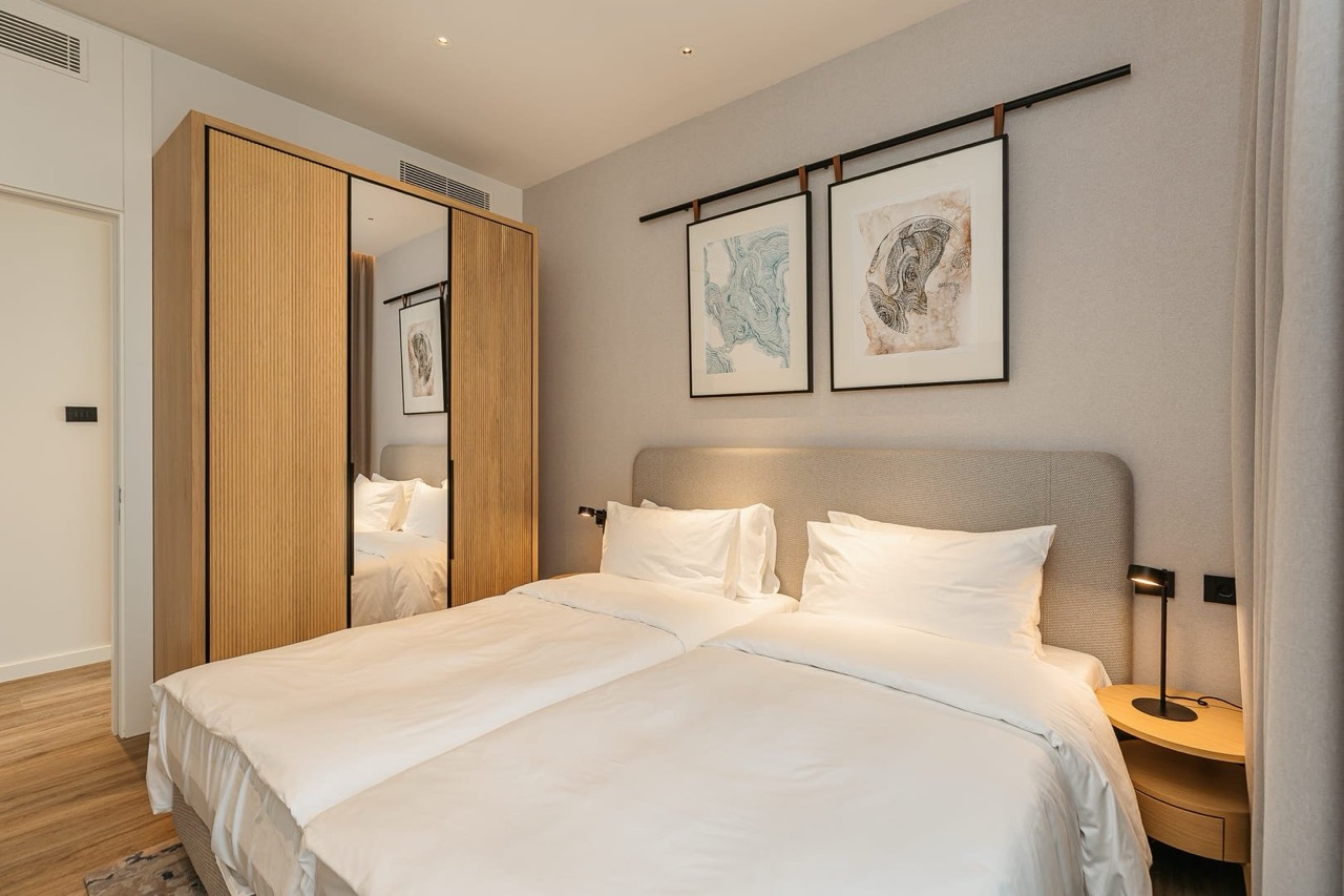 Modern bedroom in an apartment in Porto Montenegro, Tivat, Montenegro: double bed, wardrobe, and stylish interior.