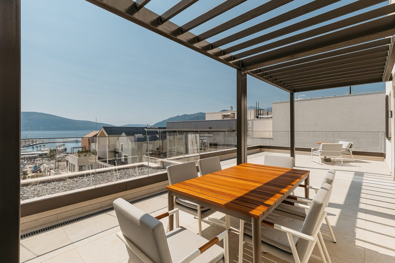 Terrace with dining area and sea view in Porto Montenegro, Tivat, Montenegro: modern furniture and pergola.
