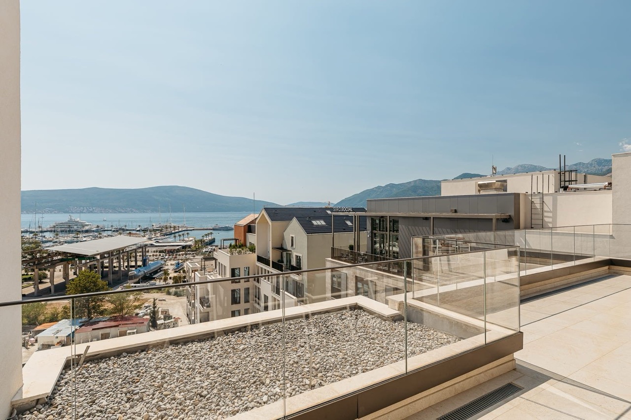Spacious terrace with views of the marina and mountains in the luxury Porto Montenegro residential complex, Tivat, Montenegro.
