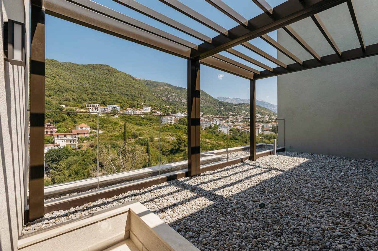 Terrace with a pergola and panoramic mountain views in an apartment in Porto Montenegro, Tivat, Montenegro.