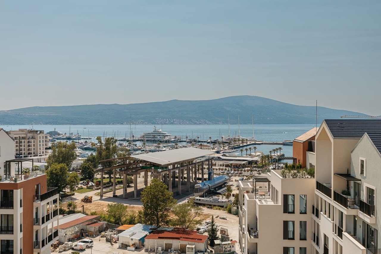 View of Porto Montenegro marina and yachts from an apartment in Tivat, Montenegro: modern architecture and a seascape.