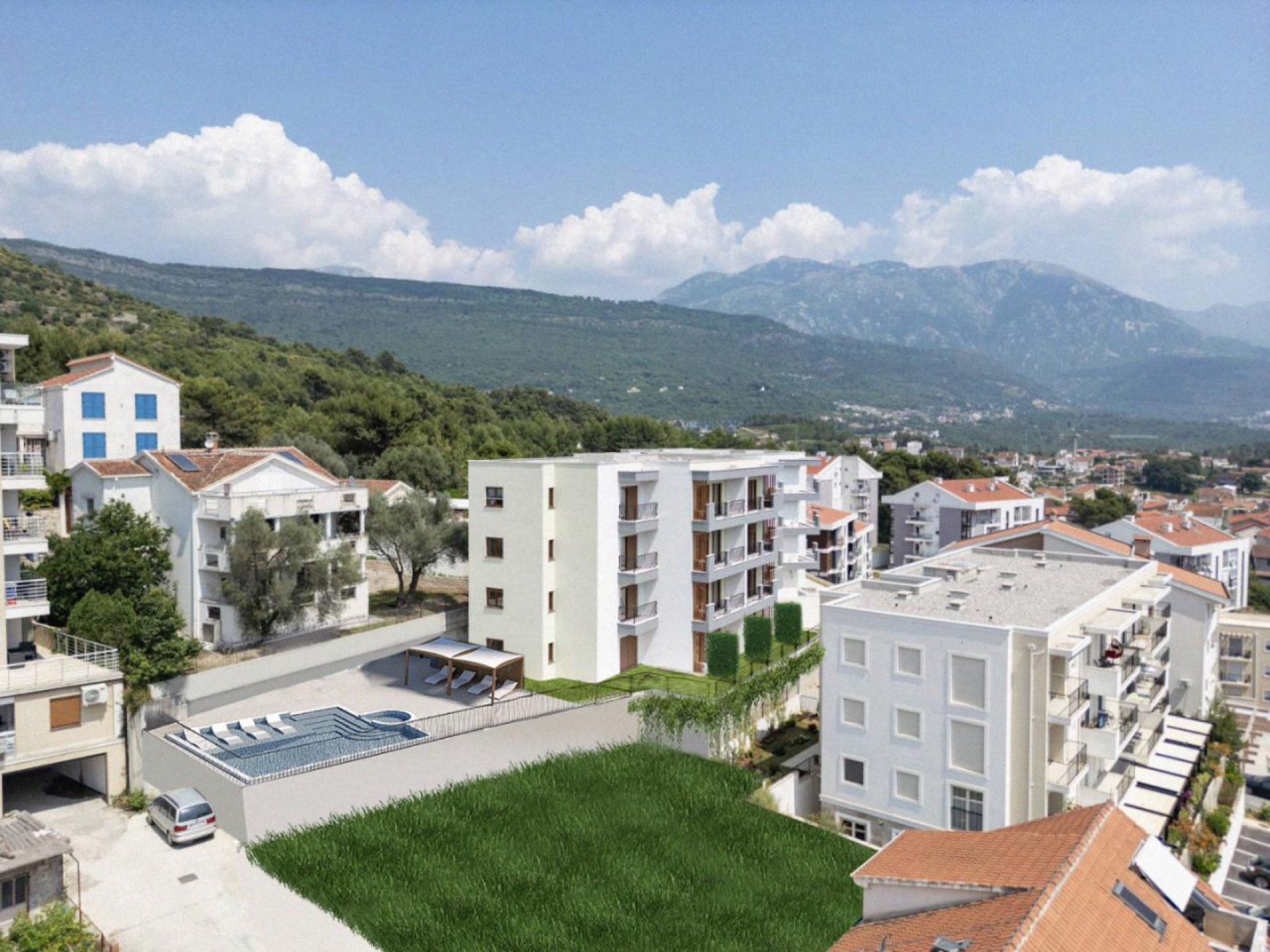 Modern residential complex with a pool in Tivat, Montenegro: view of the building, mountains, and landscaped grounds.