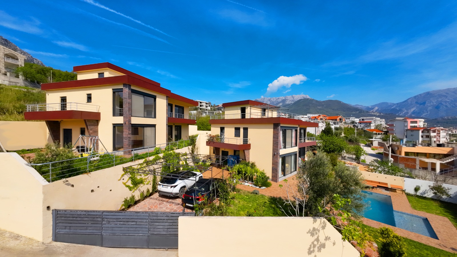 Modern villas in Bar, Montenegro: private grounds with a swimming pool, parking, and panoramic mountain views.