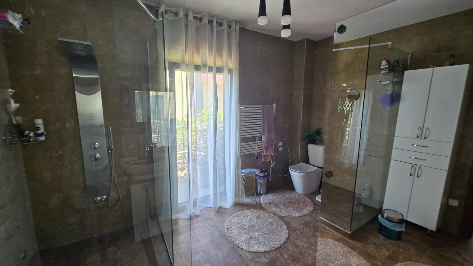 Modern bathroom with a shower cabin and marble-style finishes in a villa in Bar, Montenegro.