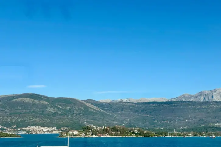 Panoramic view of the sea, bay, and mountains from the townhouse grounds in Luštica, Montenegro.