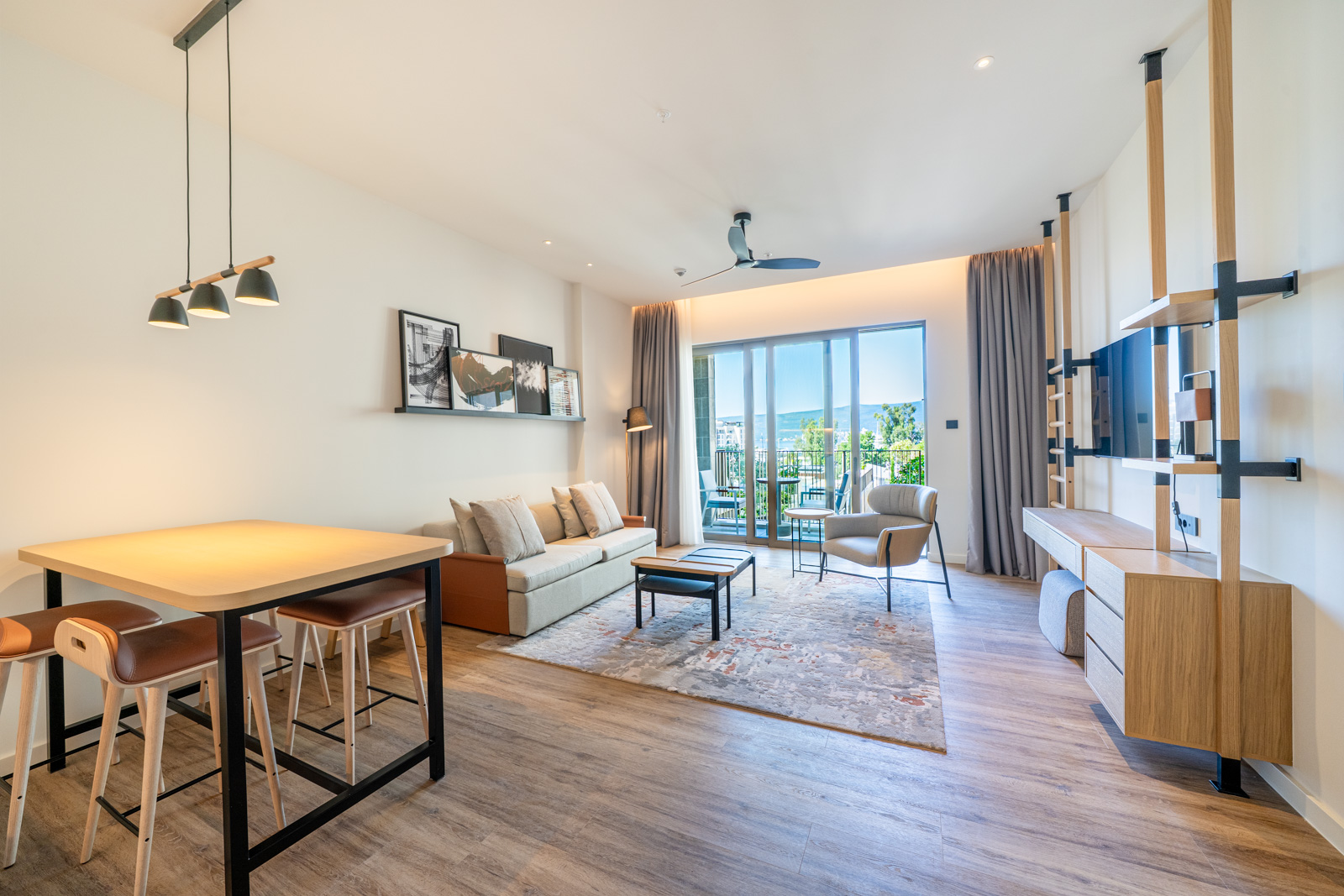 Modern living room with dining area in Porto Montenegro apartments, Tivat, Montenegro, with access to the terrace.