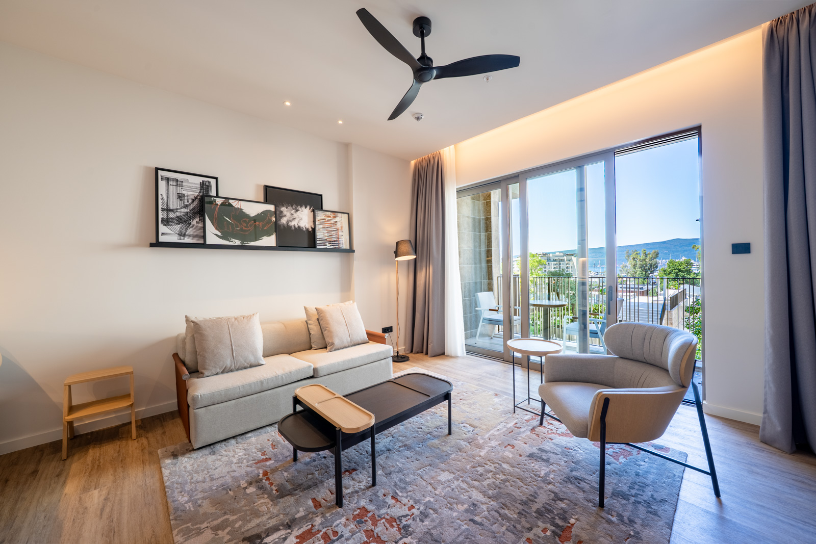 Modern living room in Porto Montenegro apartments, Tivat: stylish furniture, panoramic windows, and sea view in Montenegro