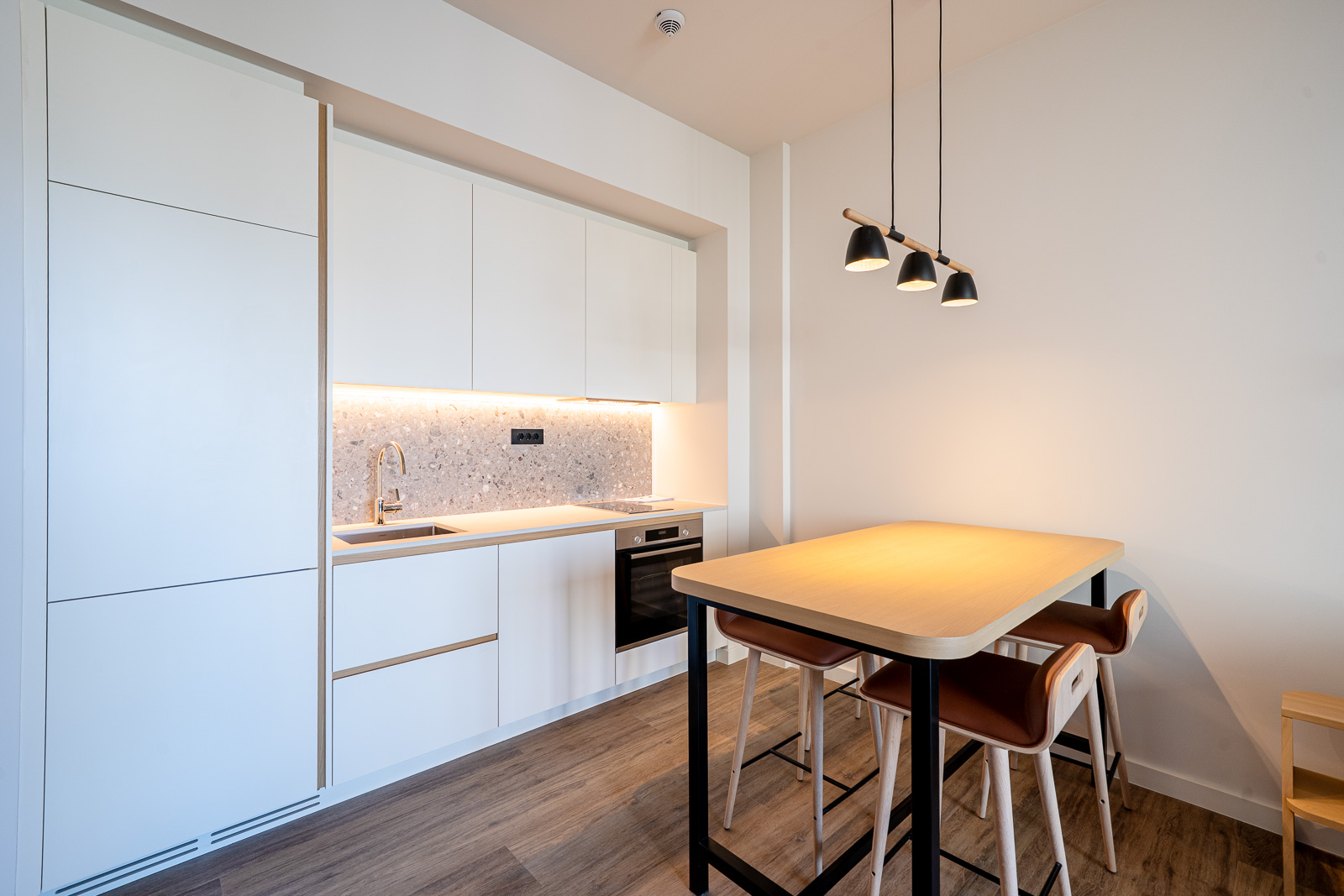 Modern kitchen in an apartment in Porto Montenegro, Tivat, Montenegro: white fronts, dining area, and stylish decor.