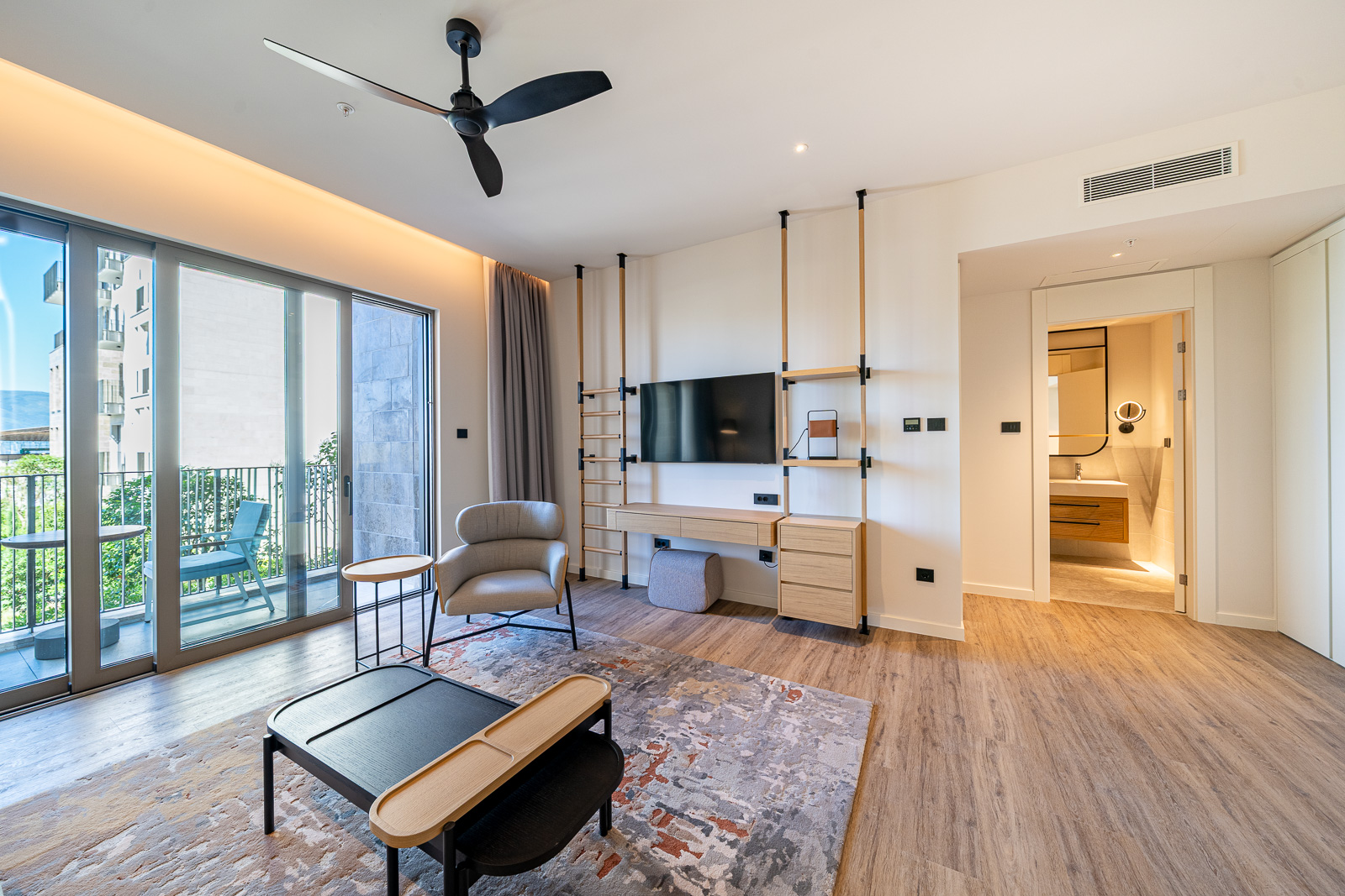 Modern living room with a terrace in Porto Montenegro apartments, Tivat, Montenegro: stylish furniture and city view.