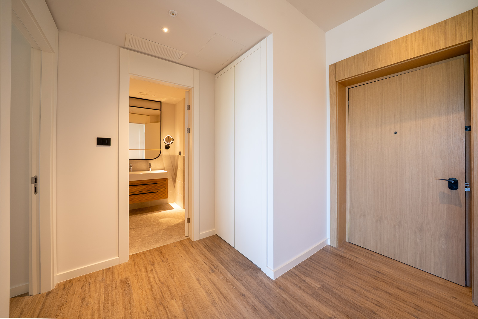 Hallway with a wooden door and built-in wardrobe in an apartment in Porto Montenegro, Tivat, Montenegro.