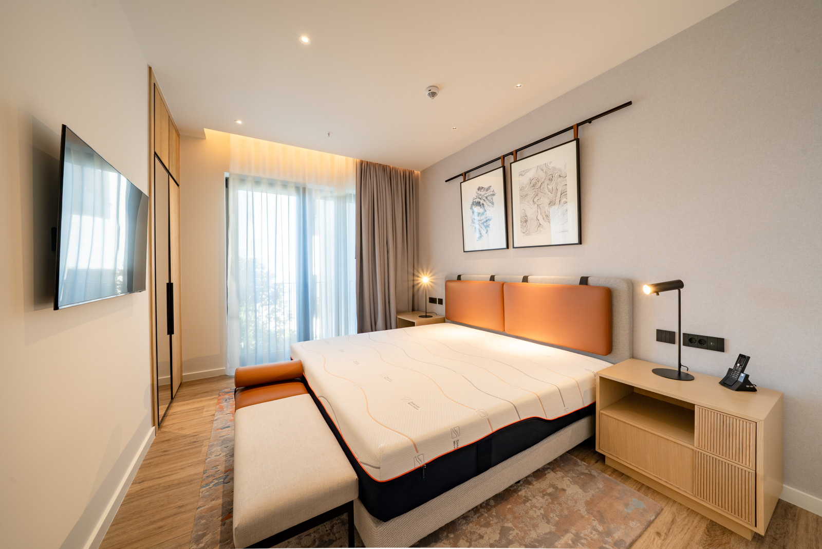 Modern bedroom in Porto Montenegro apartments, Tivat: double bed, designer furniture, and a view of the terrace.