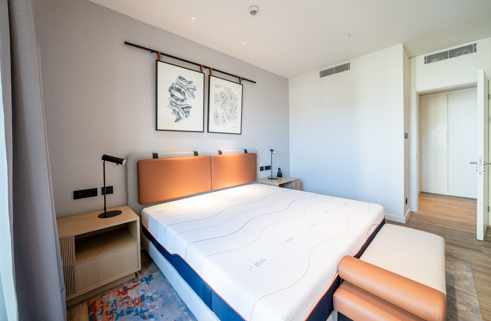Modern bedroom in an apartment in Porto Montenegro, Tivat, Montenegro: double bed with a leather headboard.