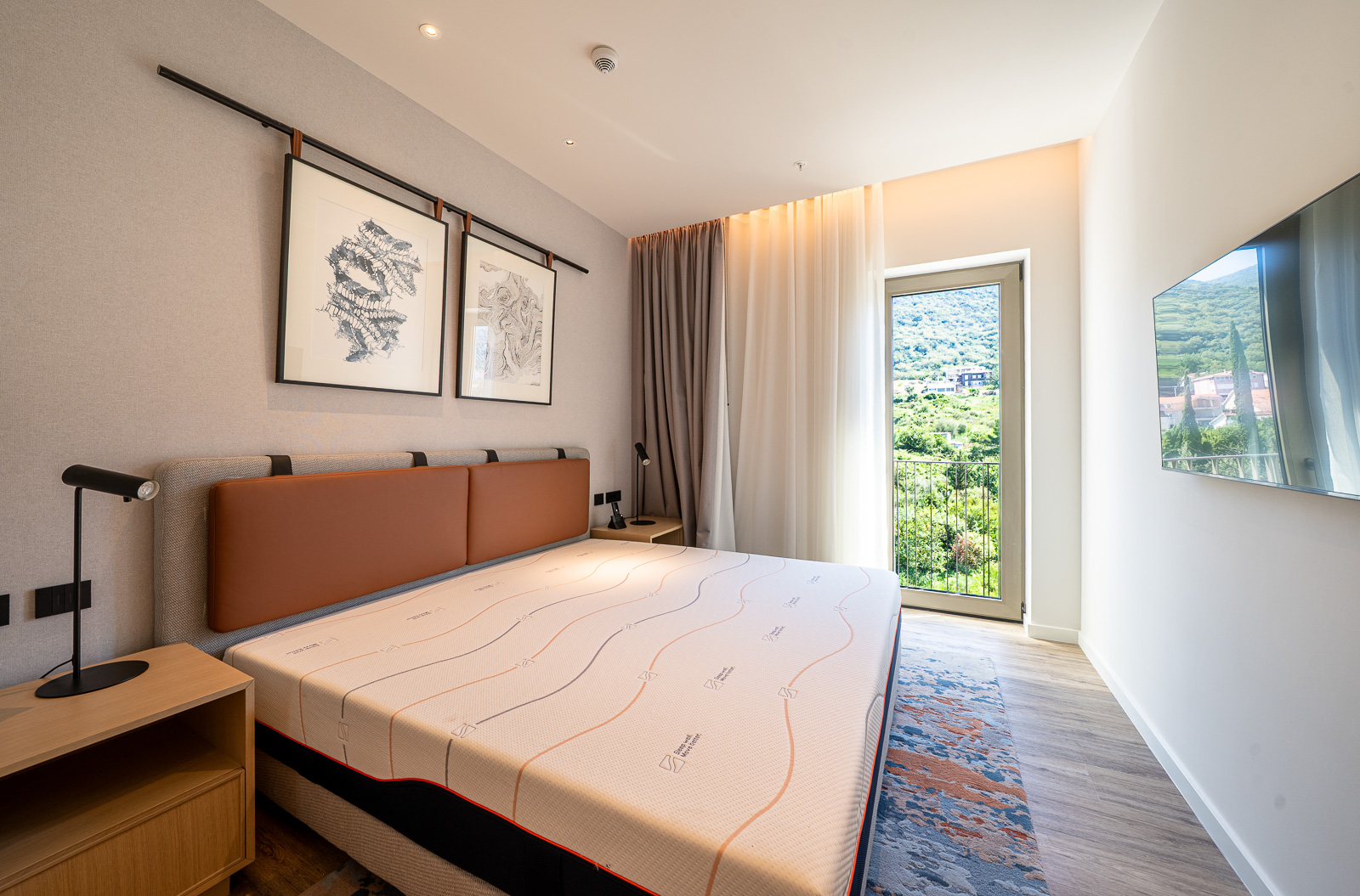 Modern bedroom in Porto Montenegro, Tivat, Montenegro: double bed, mountain view, and stylish interior.