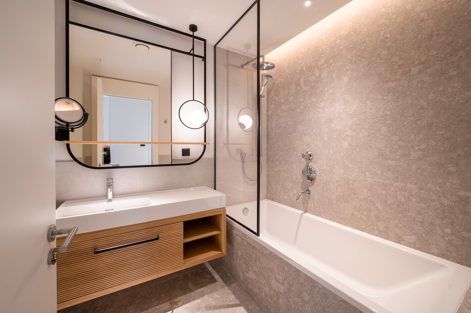 Modern bathroom with a shower cabin and wooden vanity in an apartment in Porto Montenegro, Tivat, Montenegro.