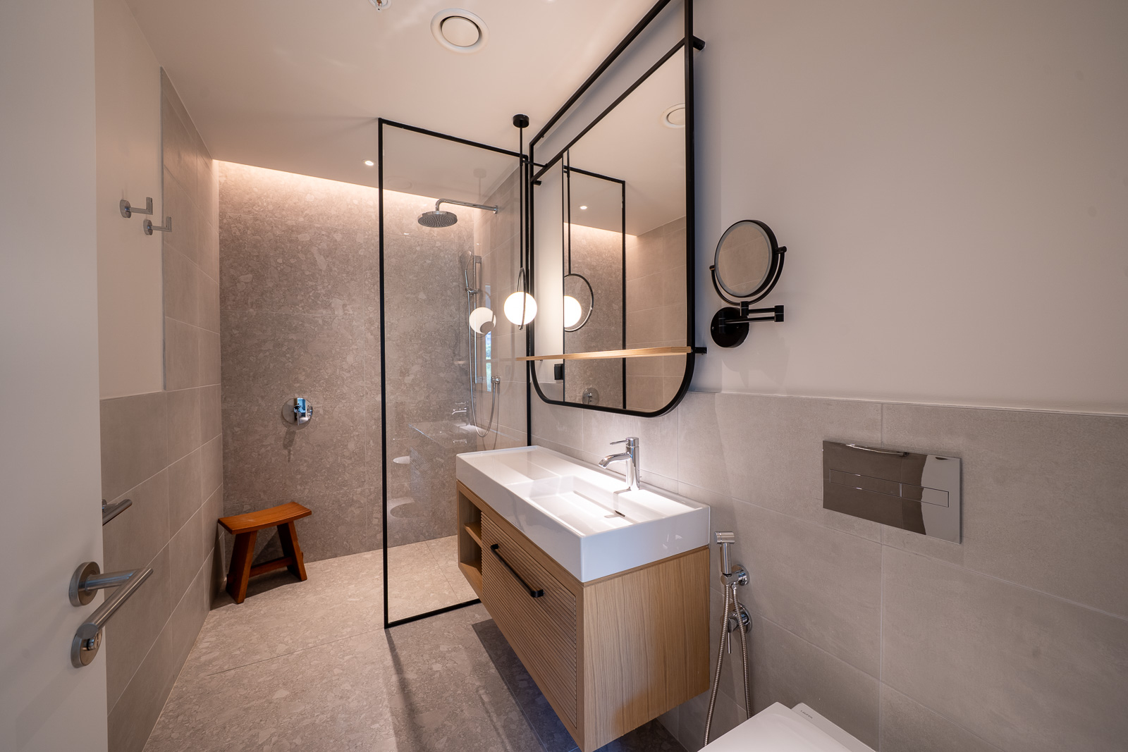Modern bathroom in an apartment in Porto Montenegro, Tivat, Montenegro: shower, stylish vanity, and mirror.