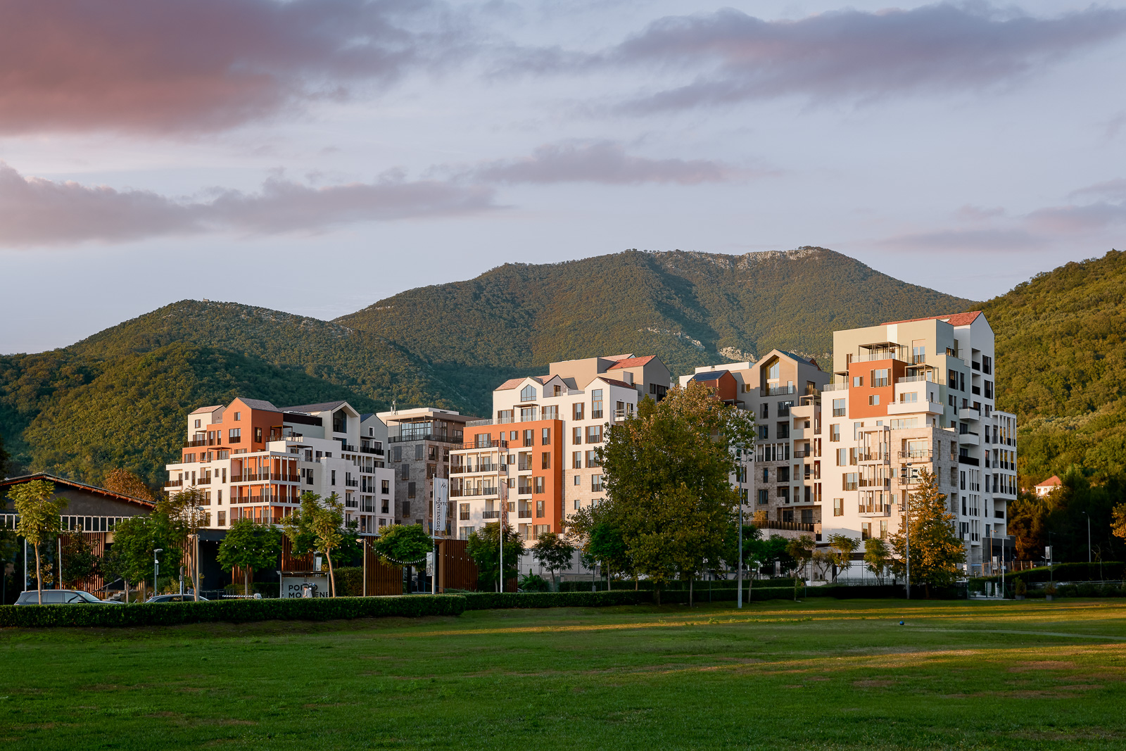 Modern residential complex in Porto Montenegro, Tivat, Montenegro: view of luxury homes against a mountain backdrop.