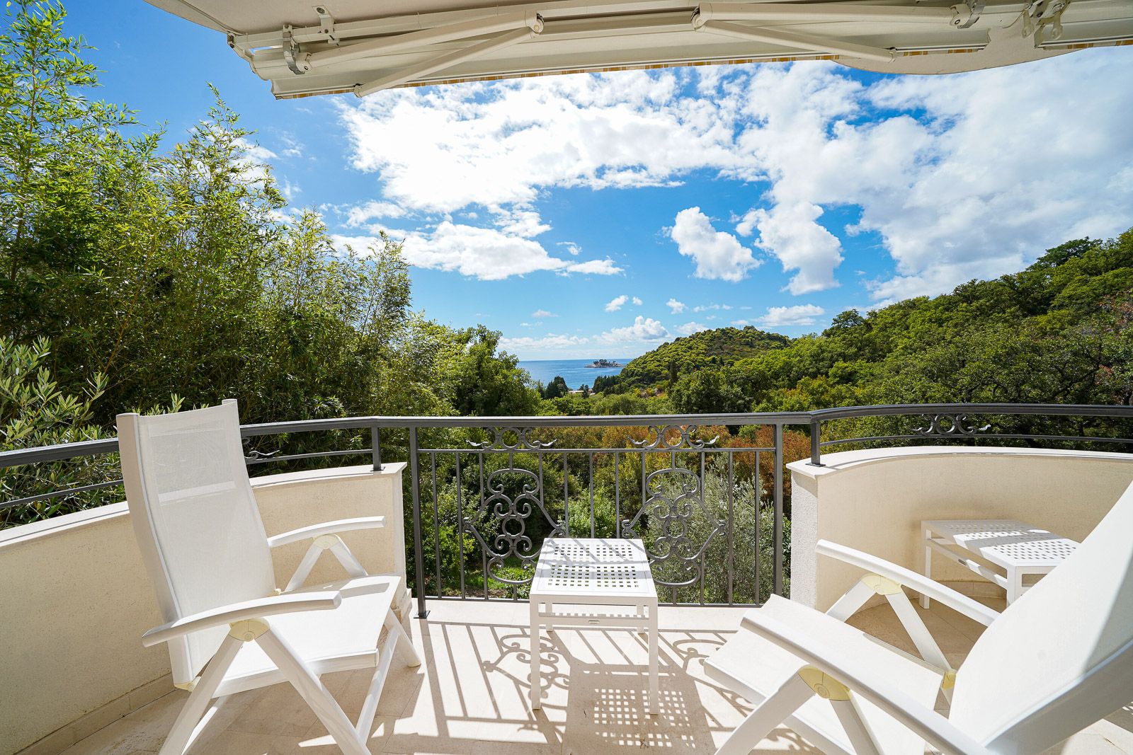 Terrace with garden furniture and panoramic views of the sea and mountains in an apartment, Petrovac, Montenegro.