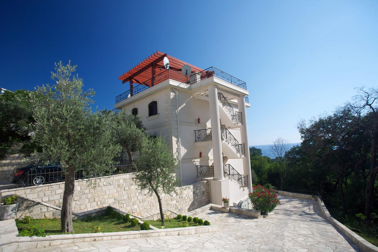 Three-story villa in Petrovac, Montenegro: facade with an open staircase, rooftop terrace, and sea view.