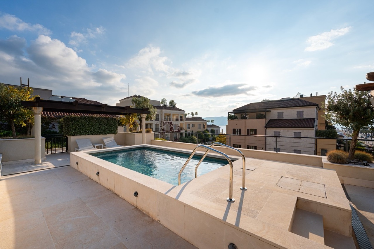 Open-air pool on the penthouse terrace in Porto Montenegro, Tivat, Montenegro, with sea views and Mediterranean style.