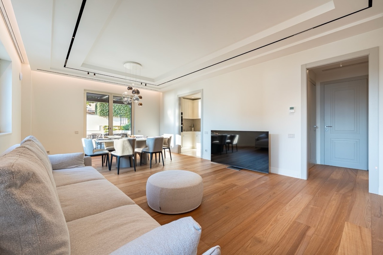 Modern living room with dining area in an apartment in Porto Montenegro, Tivat, Montenegro: bright interior and parquet flooring.