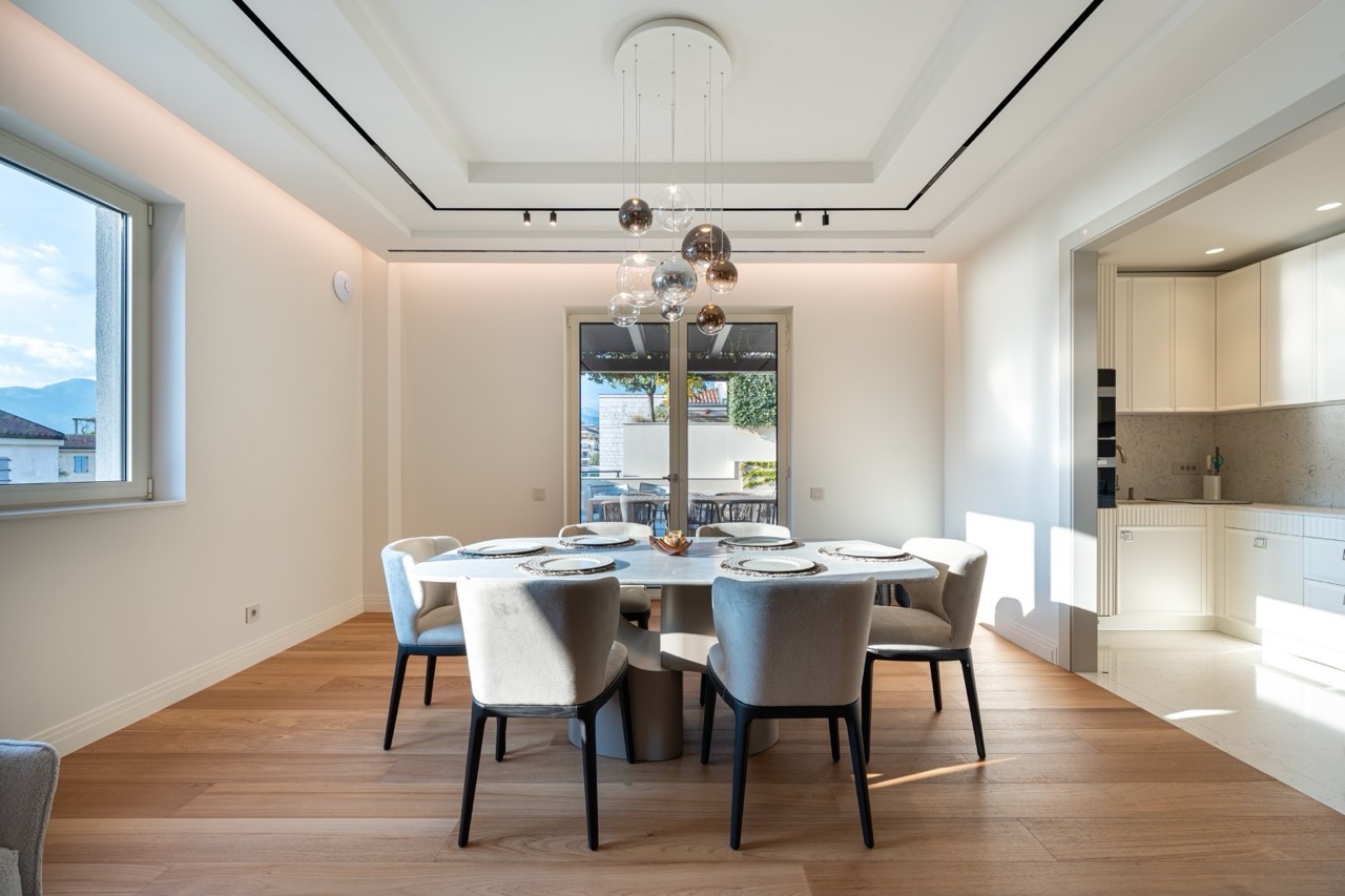 Modern dining area in an apartment in Porto Montenegro, Tivat, Montenegro: bright living room with access to the terrace.