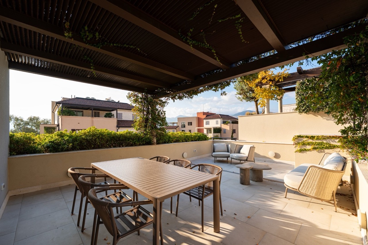 Spacious terrace with a dining area and lounge furniture in an apartment in Porto Montenegro, Tivat, Montenegro.