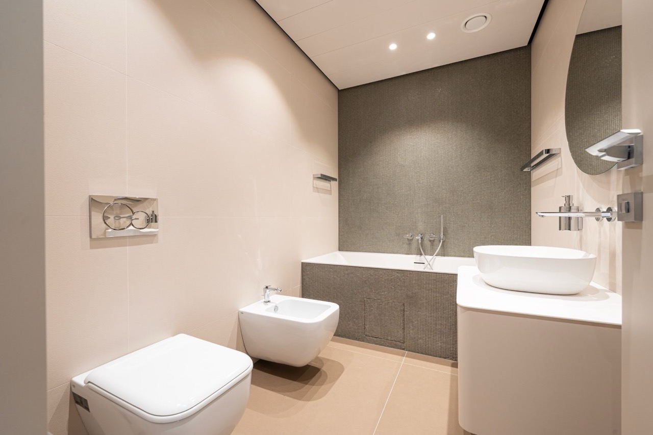 Modern bathroom in an apartment in Porto Montenegro, Tivat, Montenegro: bathtub, bidet, stylish tile finish.