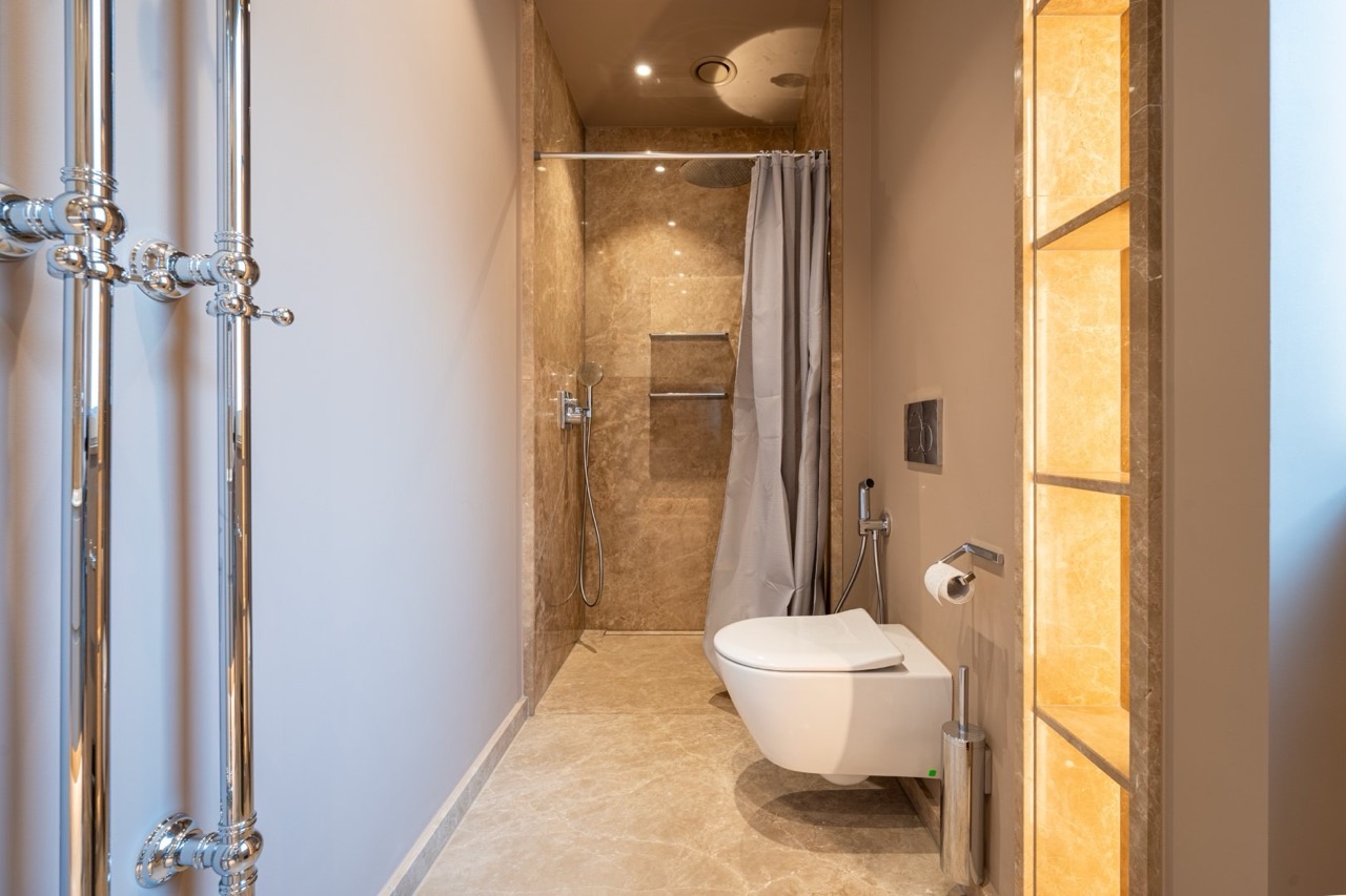 Modern bathroom with marble finishes in an apartment in Porto Montenegro, Tivat, Montenegro.