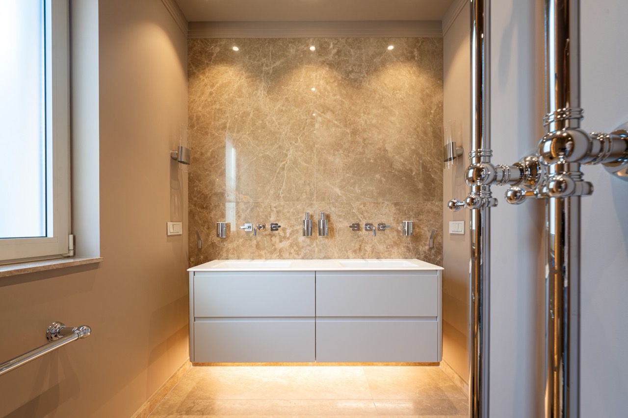 Modern bathroom with marble finishes and a floating vanity in a luxury apartment, Tivat, Montenegro.