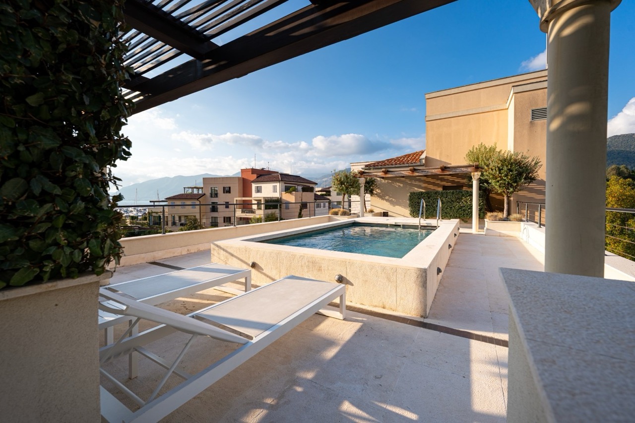 Open terrace with a pool and sun loungers in the luxury Porto Montenegro complex, Tivat, Montenegro.