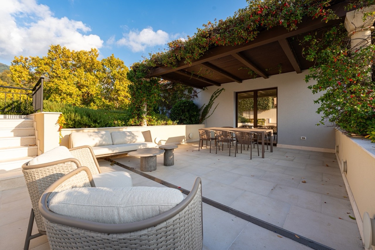 Cozy terrace with wicker furniture and a pergola in an apartment in Porto Montenegro, Tivat, Montenegro.