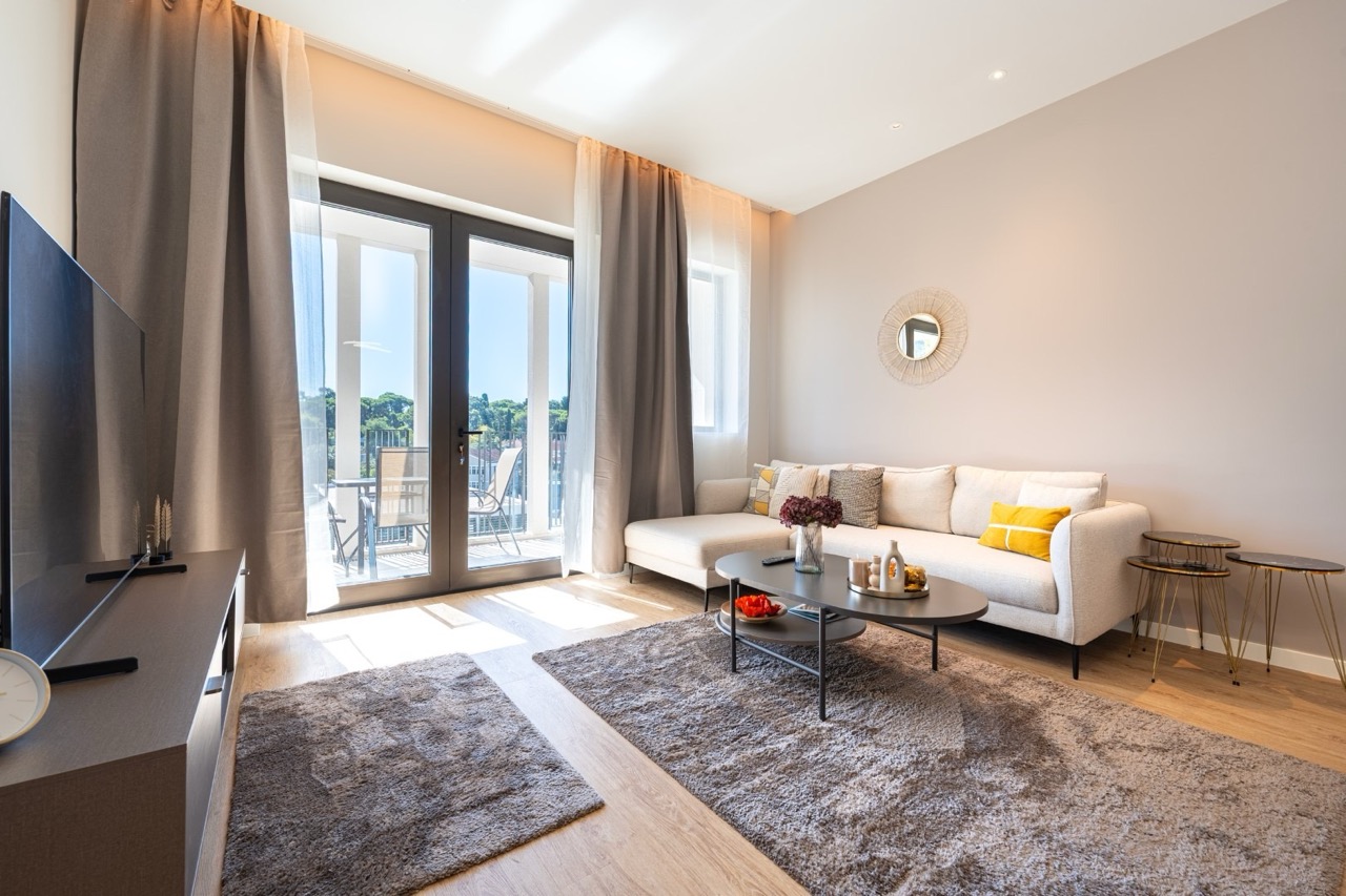 Modern living room with access to the terrace in an apartment in Porto Montenegro, Tivat, Montenegro. Bright interior.